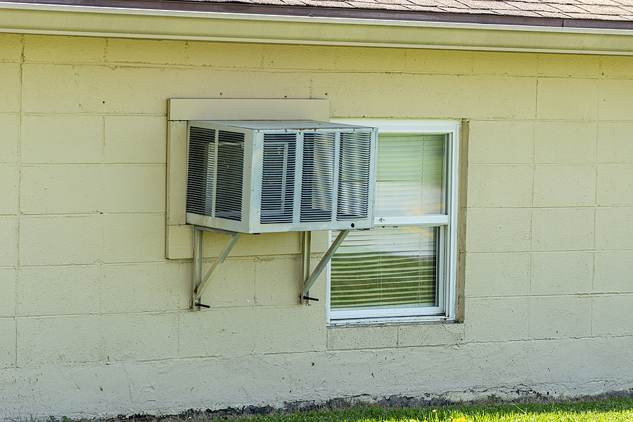 Can window units replace a failing central AC system in a rental?